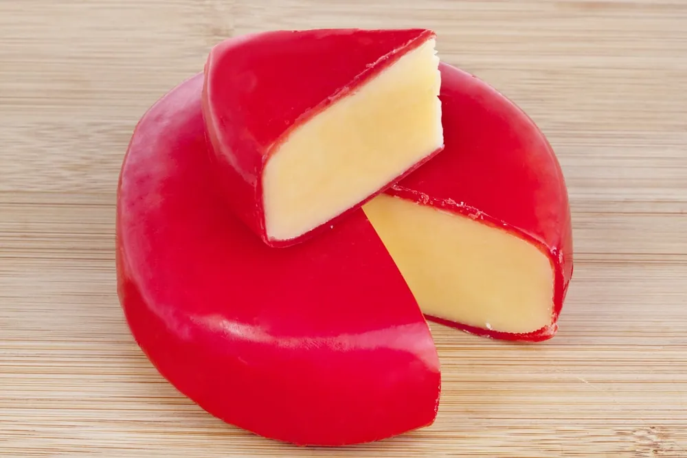 Circular,Wheel,Of,Gouda,Cheese,With,A,Wedge,Cut,Out