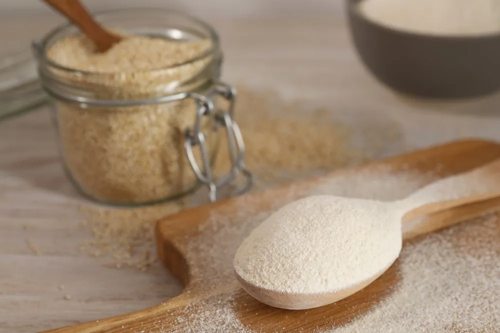 Spoon,With,Quinoa,Flour,On,Wooden,Table,,Closeup ,Space,For